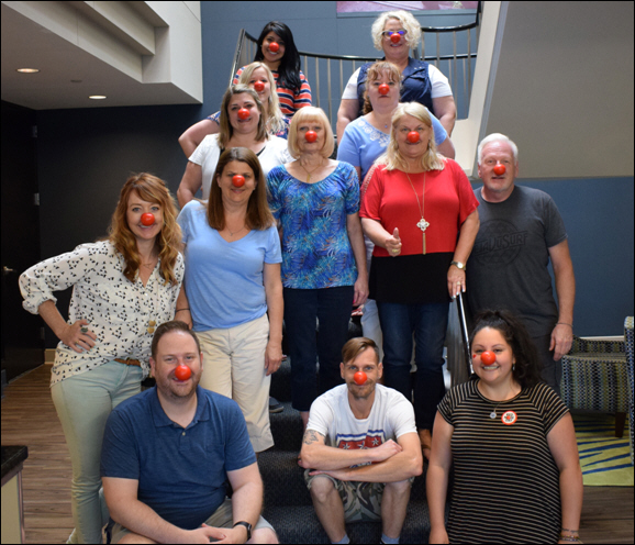 Tom Lyons, President and CEO of Global Connections Inc. (2nd row - far right) dons a Red Nose for the cause.